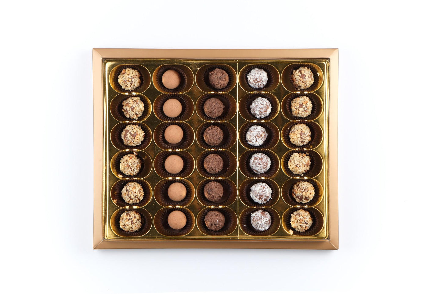 Open box of Mark Sevouni Avantgarde Collection 30-piece truffles, showcasing assorted handcrafted chocolates with hazelnut, coconut, chocolate, and coffee cream fillings.