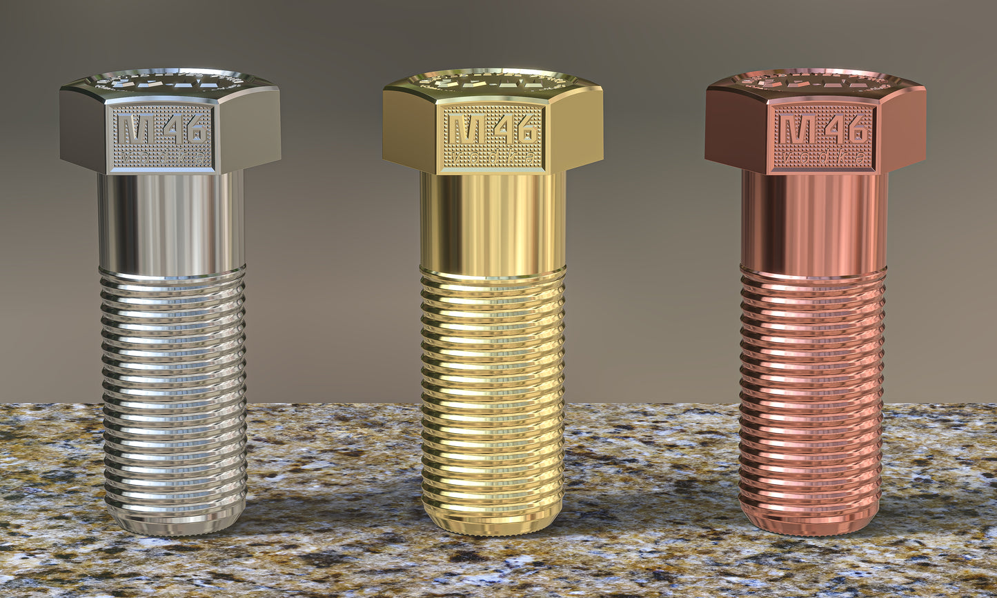 Three M46 mini vodka bottles designed as bolt-shaped collectibles in silver, gold, and copper tones, displayed on a textured stone surface.