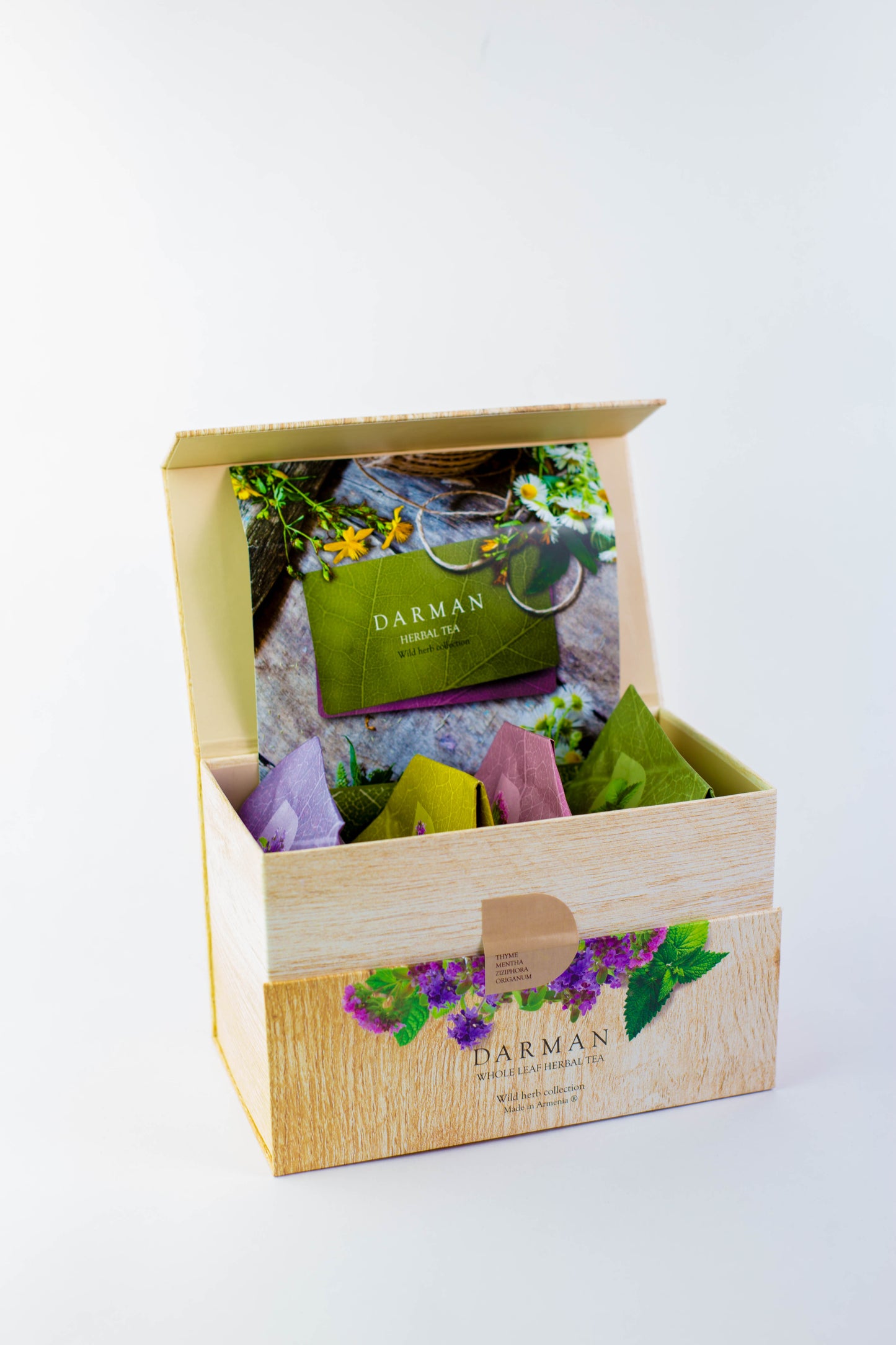 Open Darman Organic Collection Box showing vibrant tea pouches and a branded informational booklet.