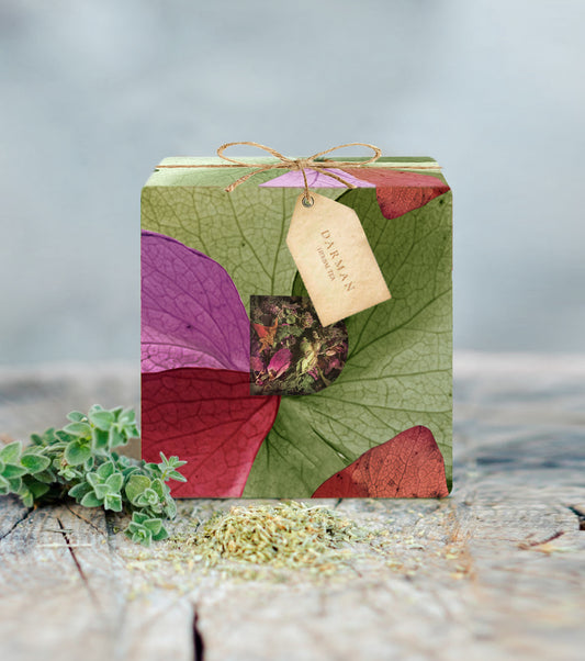 Darman herbal tea gift box with colorful leaf pattern and visible floral blend inside