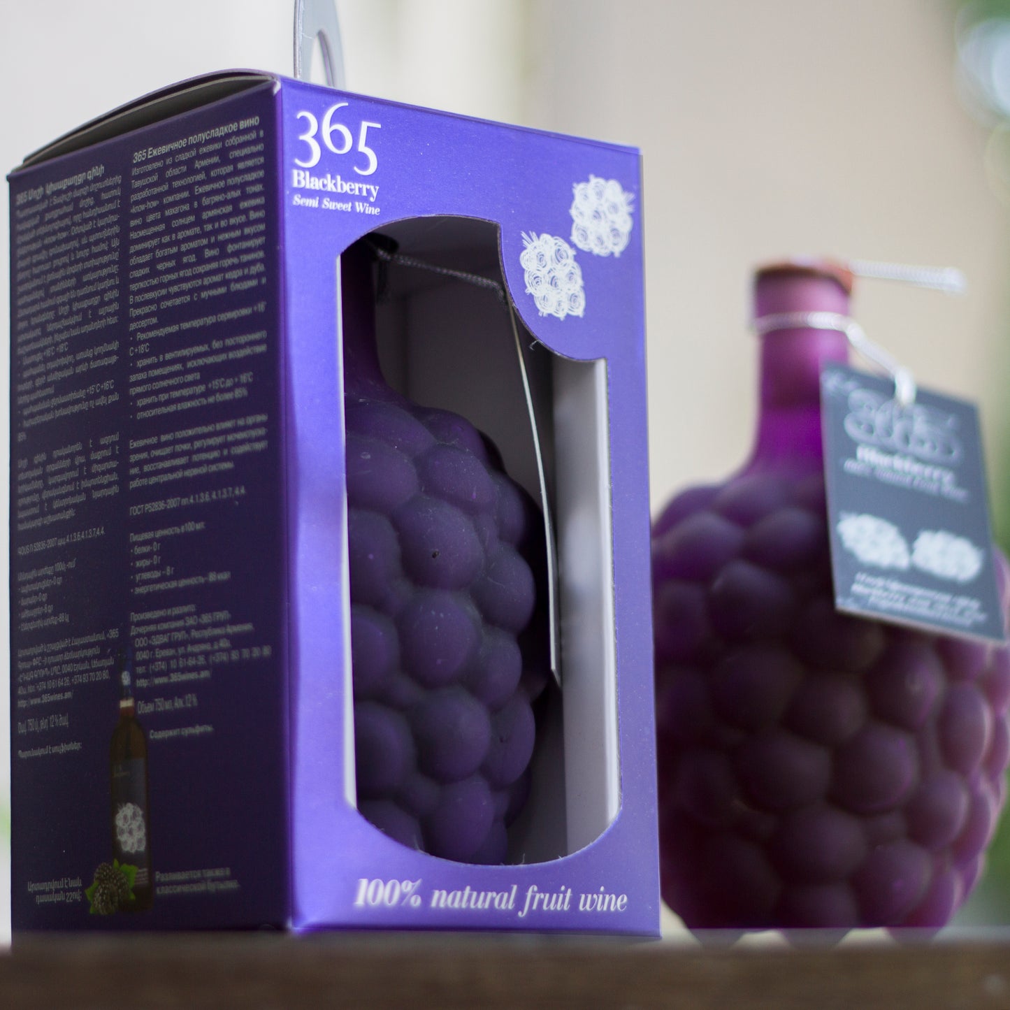 Gevorkian 365 Blackberry Wine in signature gift box, showcasing embossed fruit texture through a display window.