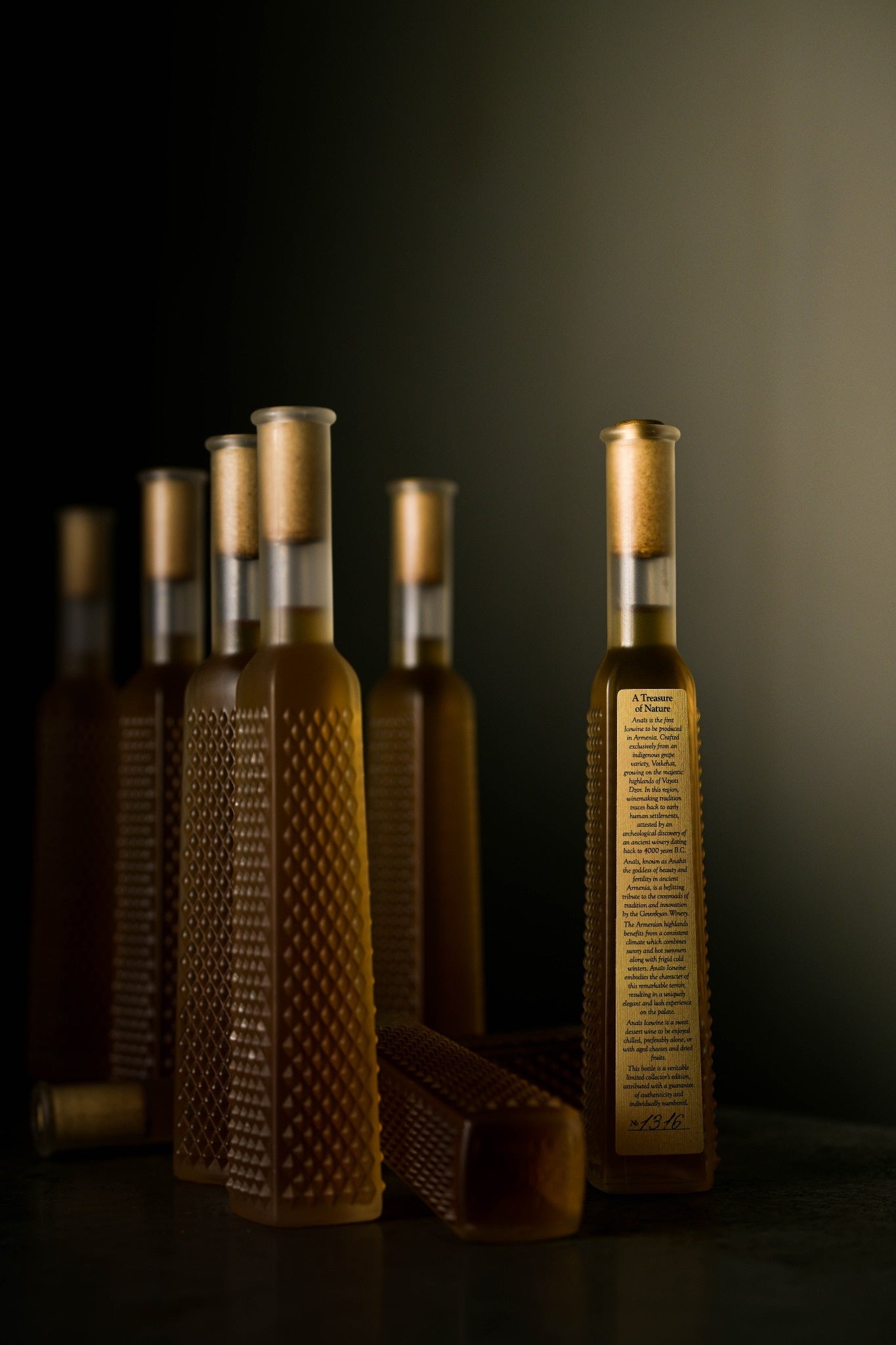 Multiple bottles of Gevorkian Anais Armenian Ice Wine Voskehat 2011 on dark background