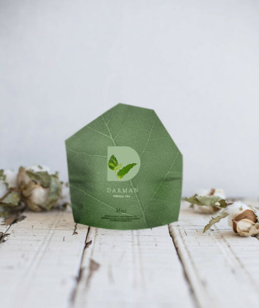Darman organic mint herbal tea in green packaging on rustic wooden surface