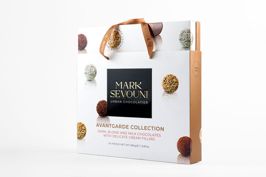 Mark Sevouni Avantgarde Collection 24-piece chocolate gift box with assorted cream-filled truffles in gold-accented packaging.