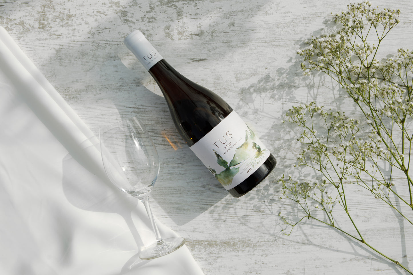 Bottle of TUS Reserve Dry White Wine 2018 made from Lalvari grapes in Tavush Province, Armenia, featuring a minimalist label with soft green watercolor design and black capsule.