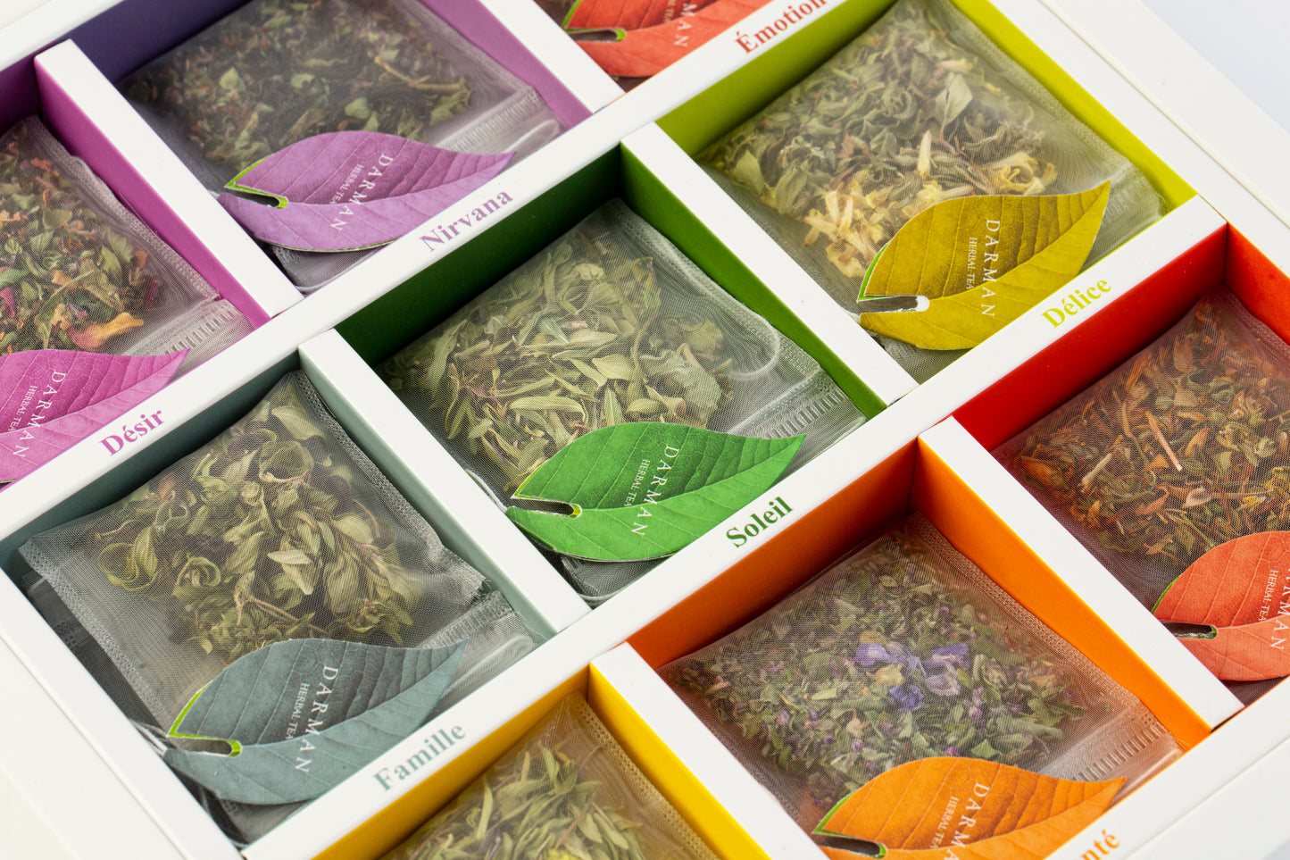 Close-up of Darman Specialty Herbal Tea box with colorful window cutouts showcasing the herbal tea bag variety inside.