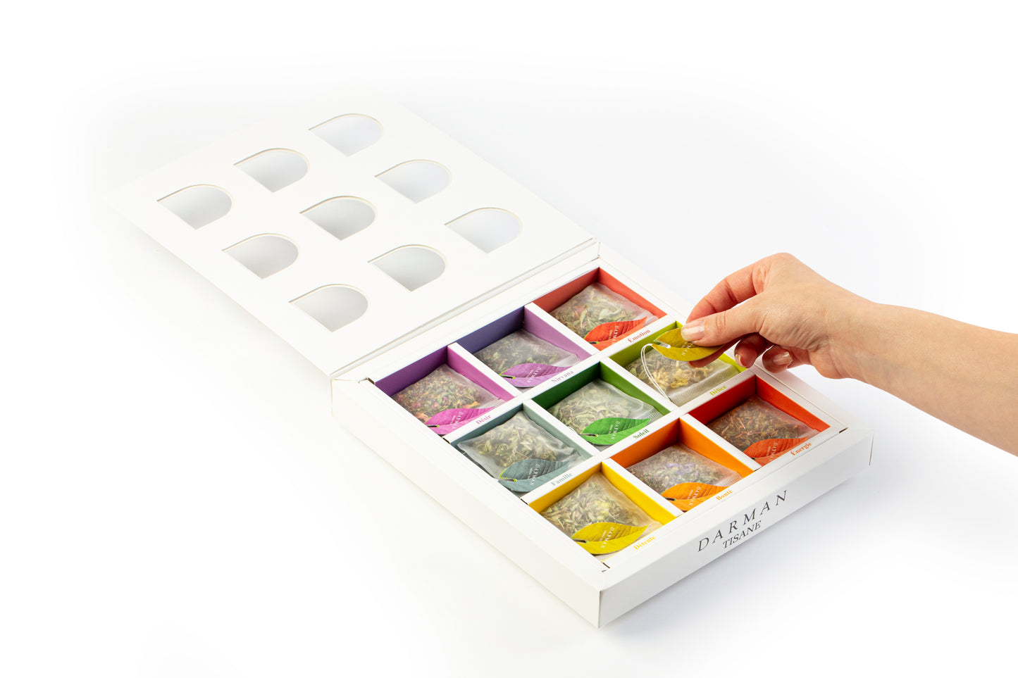 Open box view of Darman Specialty Herbal Tea displaying 9 vibrant compartments with labeled herbal tea bags in assorted colors.