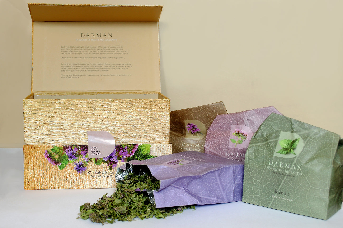 Darman Organic Collection Box fully opened with assorted herbal tea packages and loose tea leaves spilling out.