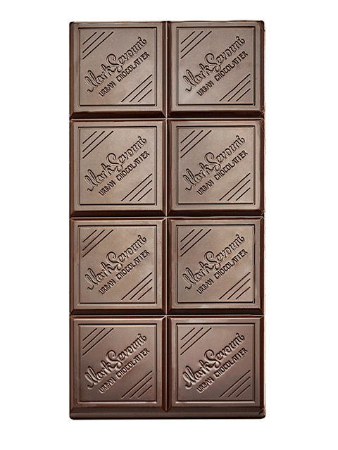 Close-up of the Mark Sevouni 82% Dark Chocolate bar, showing its elegant square segments engraved with the Urban Chocolatier logo.

