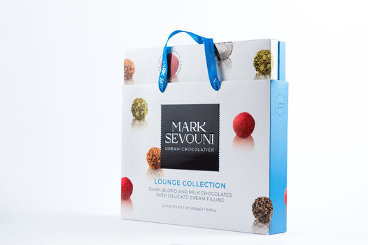 Mark Sevouni Lounge Collection gift box with 24 assorted cream-filled chocolates, in elegant blue and white packaging.
