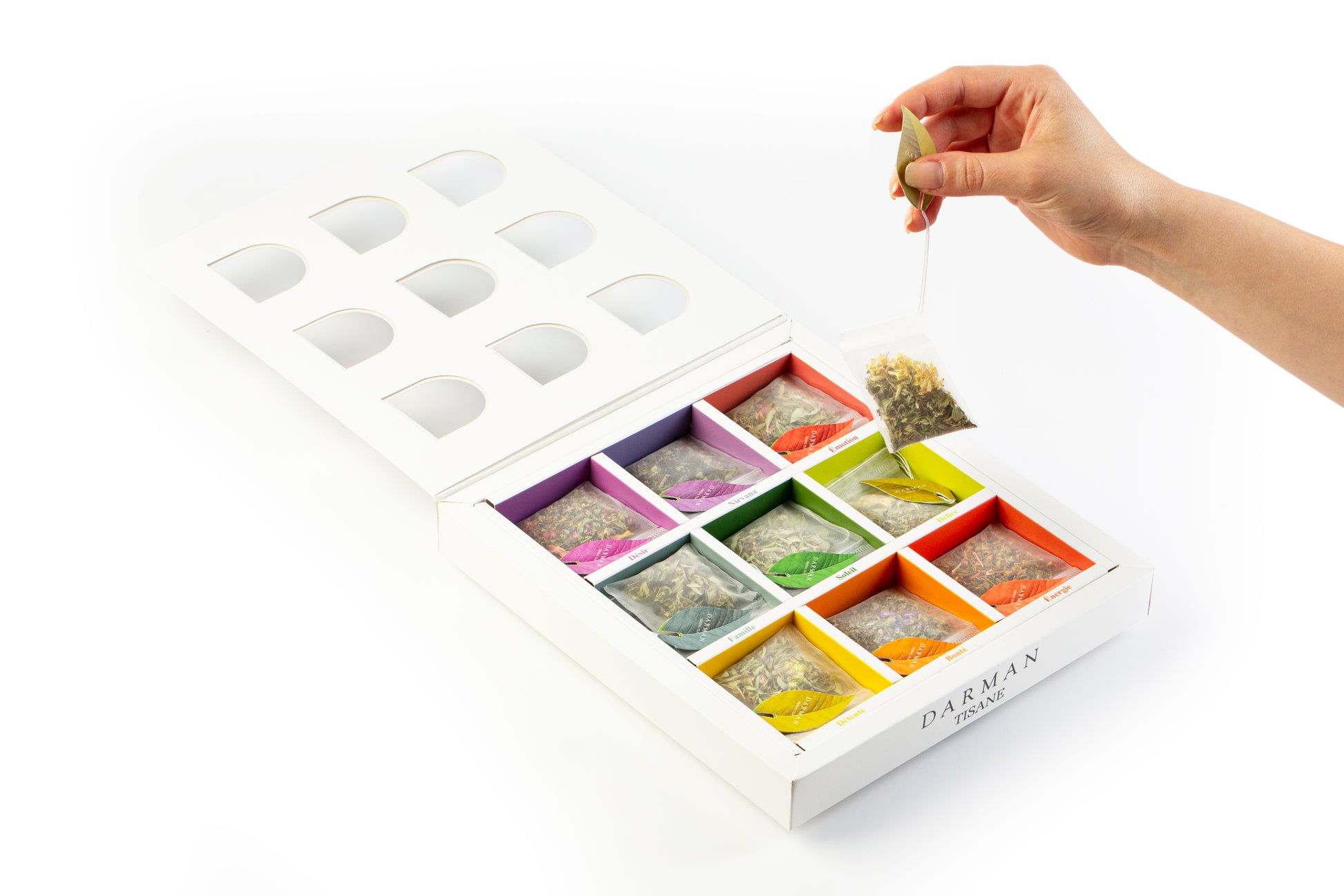 Open box view of Darman Specialty Herbal Tea displaying 9 vibrant compartments with labeled herbal tea bags in assorted colors.