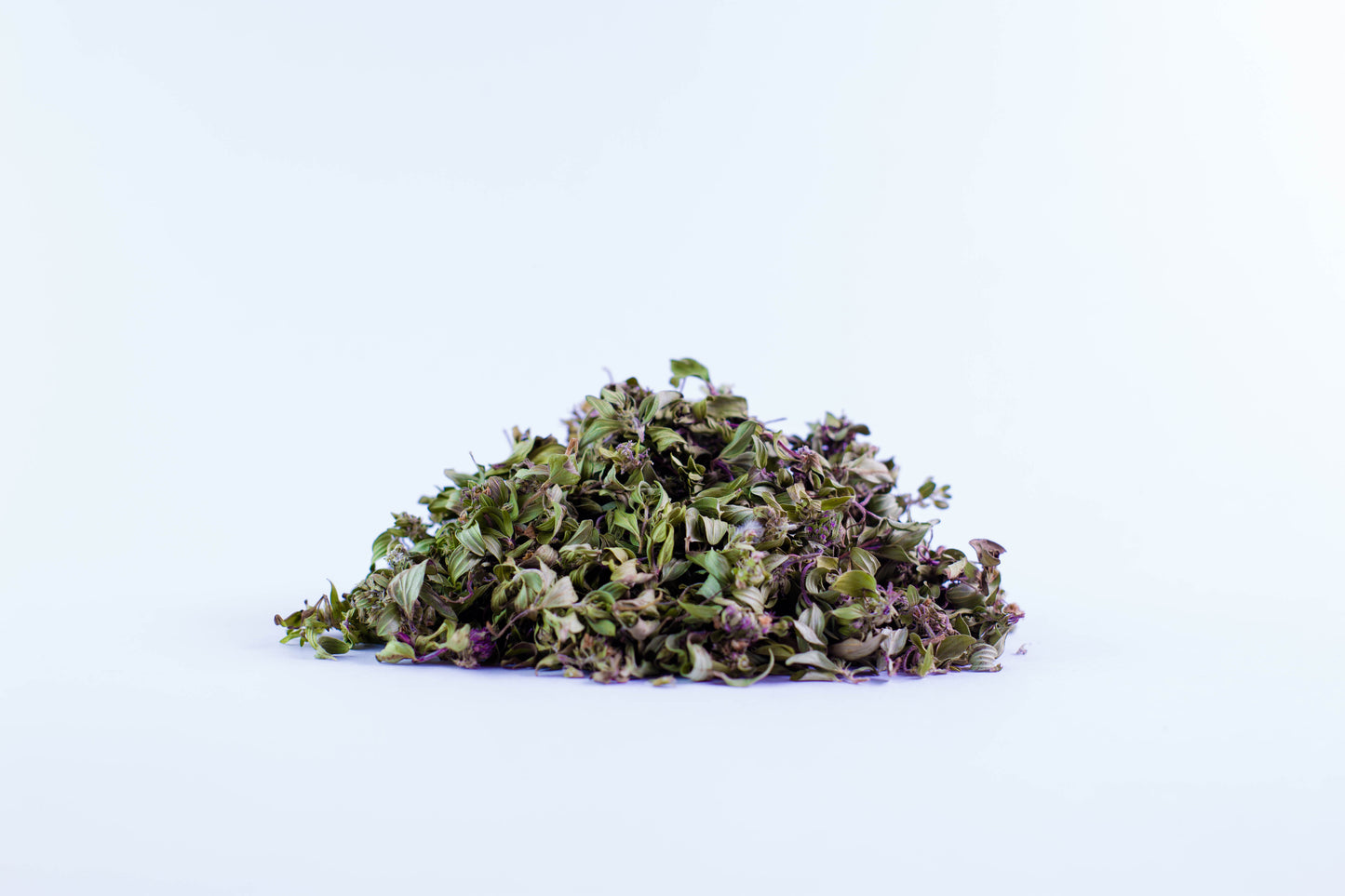 Close-up of dried thyme organic tea leaves on white background