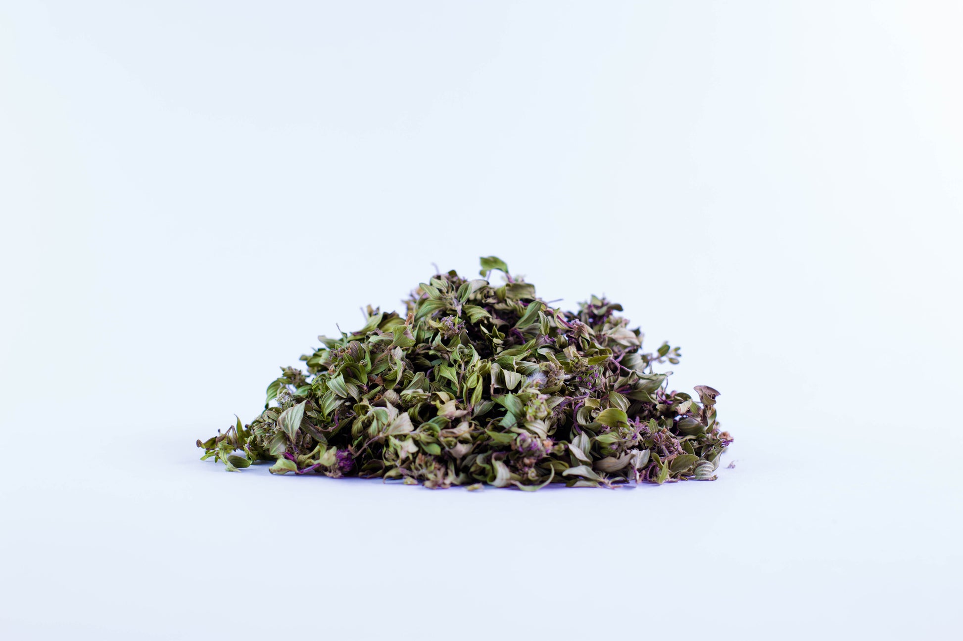 Close-up of dried thyme organic tea leaves on white background